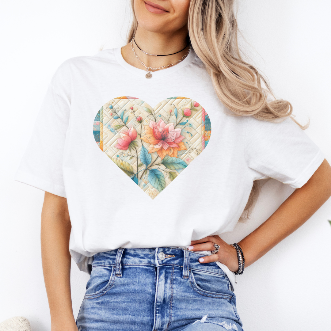 a woman wearing a white t - shirt with a floral heart on it